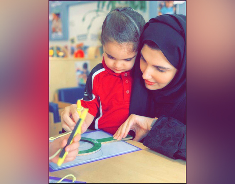 A young Qatar Academy Doha pupil with a teacher.