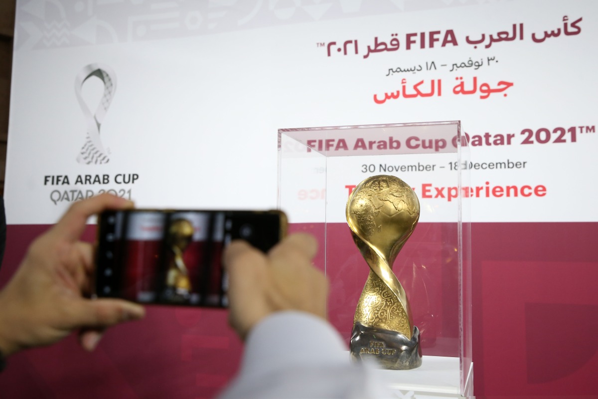 A fan takes a photograph of the FIFA Arab Cup trophy. Pic: Mohamed Farag