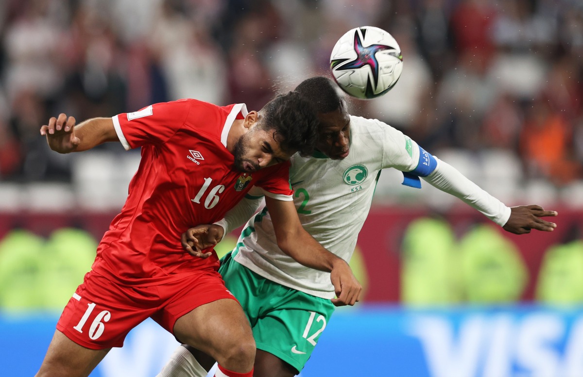 Saudi Arabia’s Saud Abdulhamid and Jordan’s Ali Olwan vie for the ball possession. 