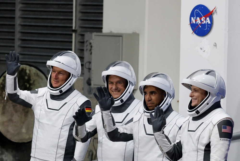 European Space Agency (ESA) astronaut Matthias Maurer of Germany, NASA astronauts Raja Chari, Tom Marshburn, and Kayla Barron wave while departing the crew quarters for launch aboard a SpaceX Falcon 9 rocket on a mission to the International Space Station at the Kennedy Space Center in Cape Canaveral, Florida, U.S., November 10, 2021. REUTERS/Joe Skipper/File Photo