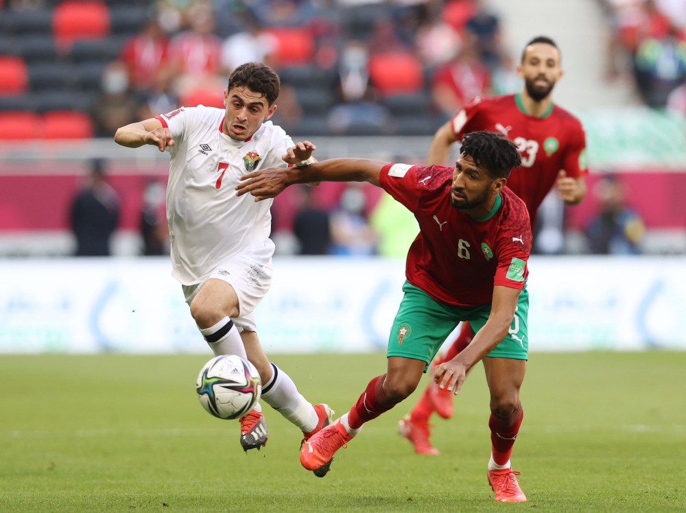 Jordan's Mohamed Zraiq in action with Morocco's Mohammed Ali Bemammer Reuters/Ibraheem Al Omari