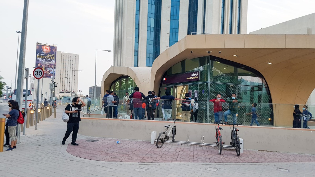 Commuters wait outside a metro station as services temporarily halted. Picture by: Abdul Basit/ The Peninsula