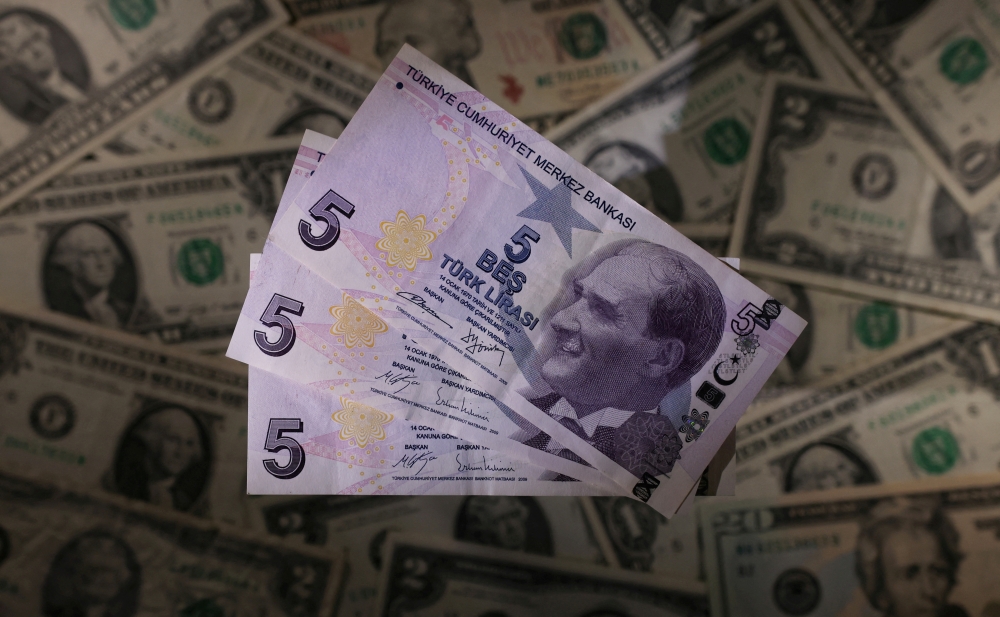 FILE PHOTO: Turkish lira banknotes are seen placed on U.S. Dollar banknotes in this illustration taken, November 28, 2021. REUTERS/Dado Ruvic/Illustration