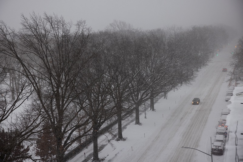 Cars drive along the snow-covered Central Park West avenue after a powerful Nor'easter storm hit the region in New York City, U.S., January 29, 2022. REUTERS/Caitlin Ochs
