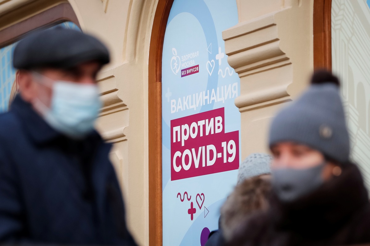 FILE PHOTO: People are seen outside a vaccination centre in the State Department Store, GUM, amid the outbreak of the coronavirus disease (COVID-19), in central Moscow, Russia January 18, 2021 REUTERS/Shamil Zhumatov

