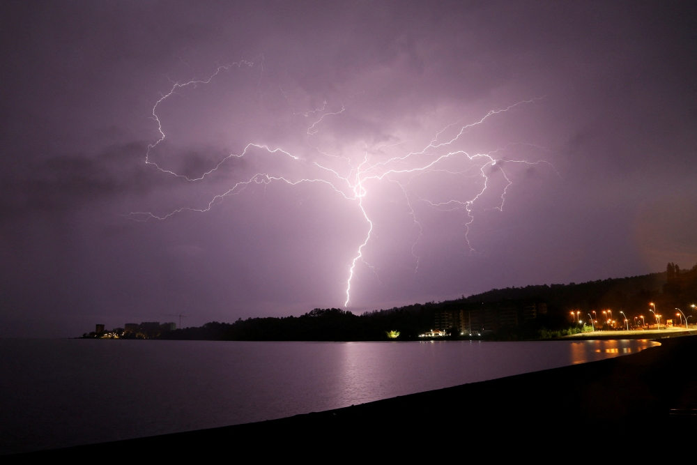 Lightning strikes are seen above Villarrica lake, in Villarrica, Chile, December 7, 2021. REUTERS/Cristobal Saavedra Escobar/File Photo