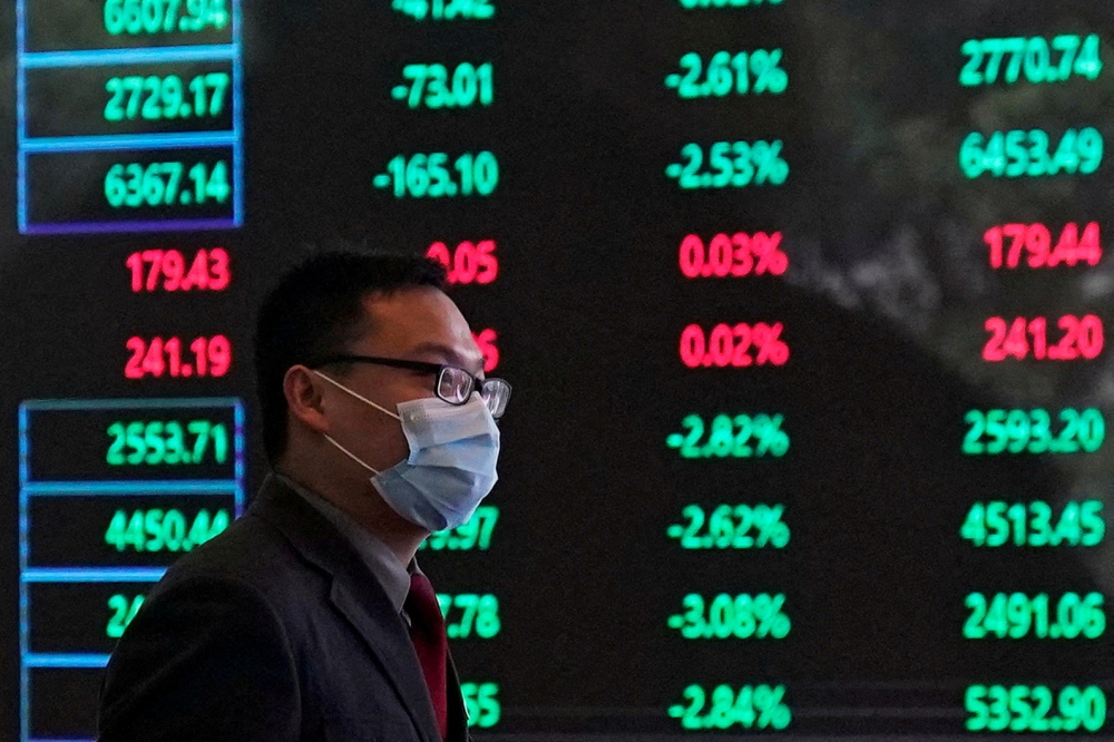 A man wearing a protective mask is seen inside the Shanghai Stock Exchange building at the Pudong financial district in Shanghai, China February 28, 2020. Reuters/Aly Song//File Photo