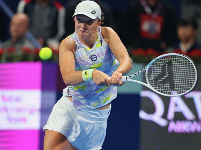 Iga Swiatek of Poland returns the ball to Aryna Sabalenka of Belarus during their 
quarter-final match at Khalifa International Tennis and Squash Complex, yesterday.