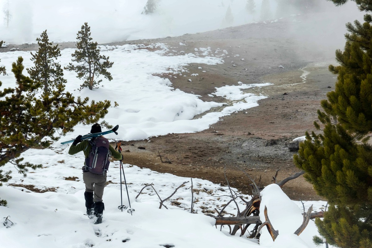 A Yellowstone Expeditions guide carries skis near Violet Springs. Photo for The Washington Post by Dina Mishev
