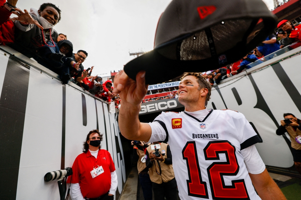 Tampa Bay Buccaneers quarterback Tom Brady (12) hands his hat to a fan after beating the Philadelphia Eagles 31-15 in a NFC Wild Card playoff football game at Raymond James Stadium. Mandatory Credit: Nathan Ray Seebeck-USA TODAY Sports TPX IMAGES OF THE DAY/File Photo