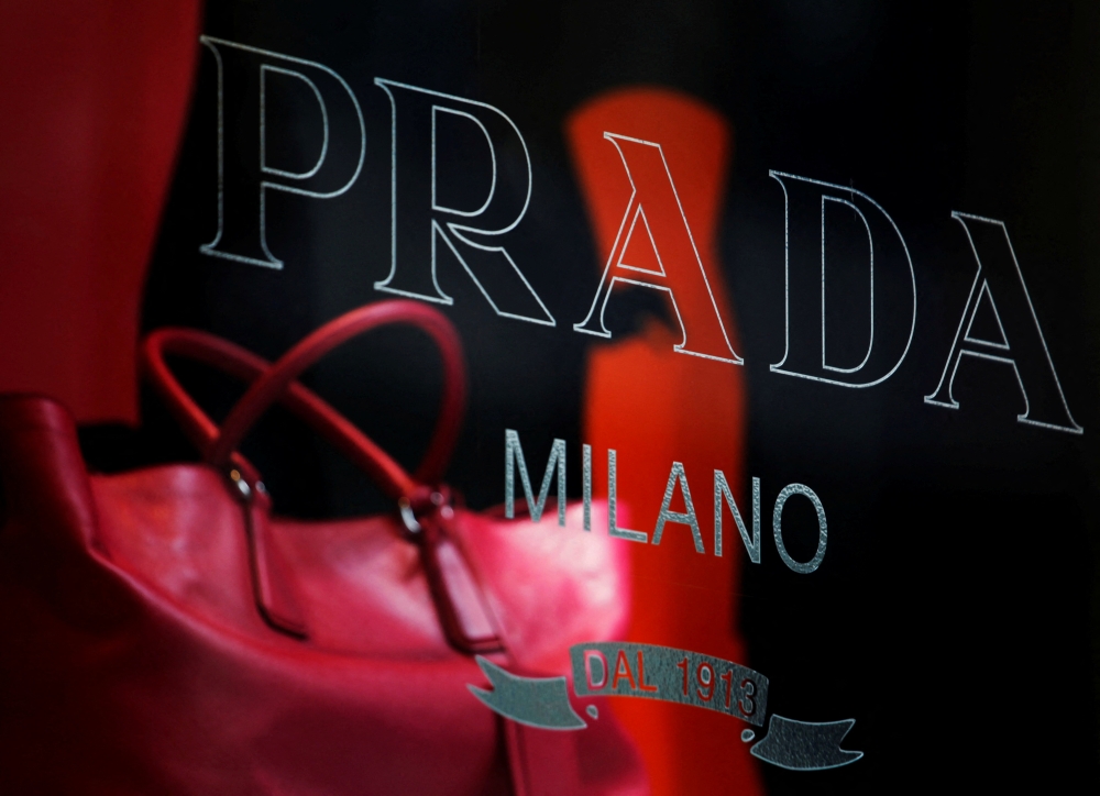 A handbag is seen behind a display window at a Prada store in Hong Kong June 3, 2011. REUTERS/Bobby Yip/File Photo