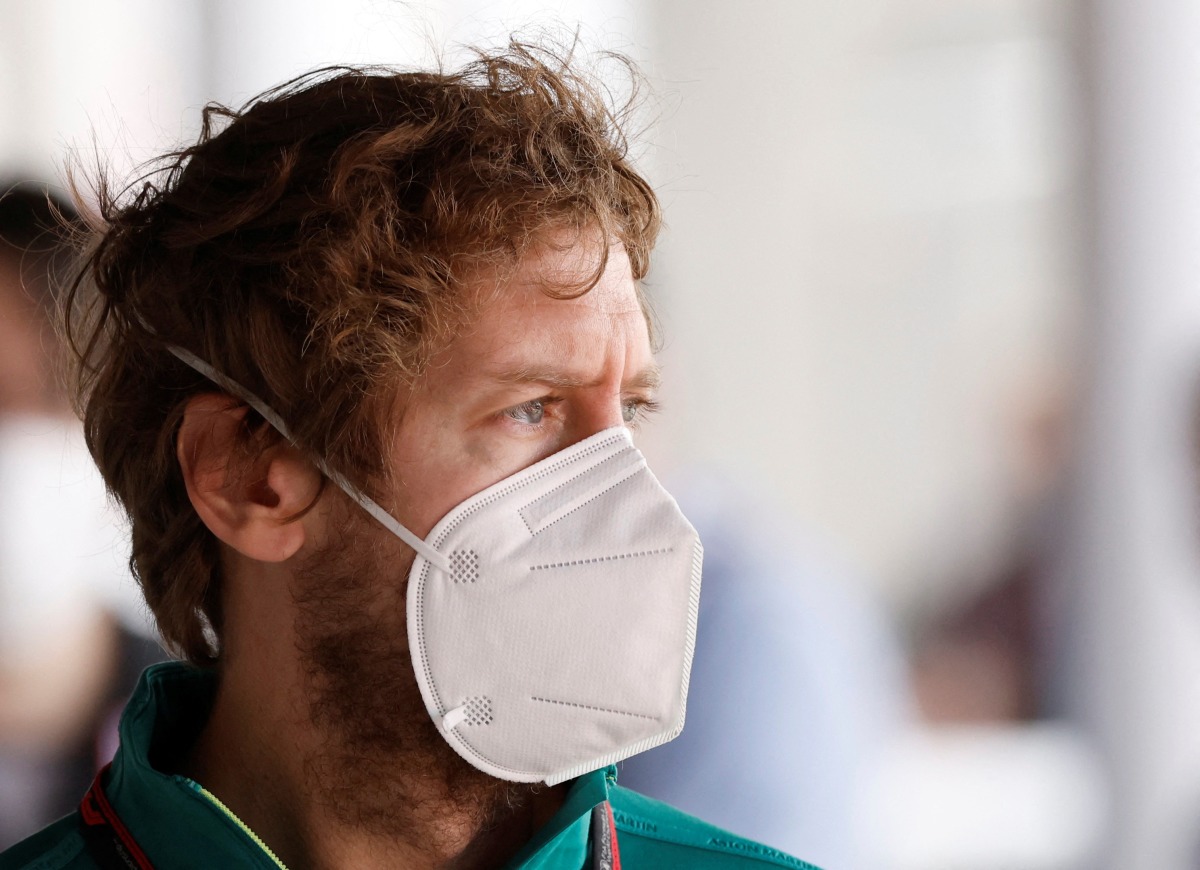 FILE PHOTO: Aston Martin's Sebastian Vettel wears a protective face mask during testing REUTERS/Albert Gea/File Photo
