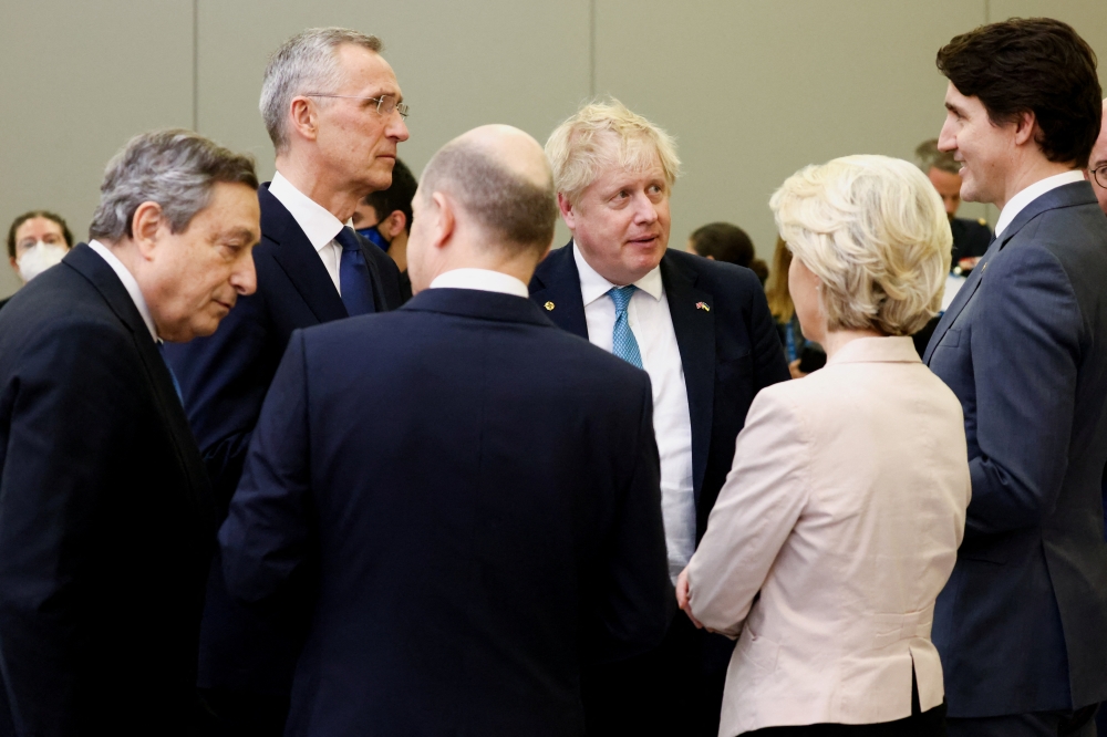 Italy's Prime Minister Mario Draghi, NATO Secretary General Jens Stoltenberg, British Prime Minister Boris Johnson, Canada's Prime Minister Justin Trudeau, European Commission President Ursula von der Leyen and Germany's Chancellor Olaf Scholz speak before G7 leaders' family photo during a NATO summit on Russia's invasion of Ukraine, at the alliance's headquarters in Brussels, Belgium March 24, 2022. REUTERS/Henry Nicholls/Pool