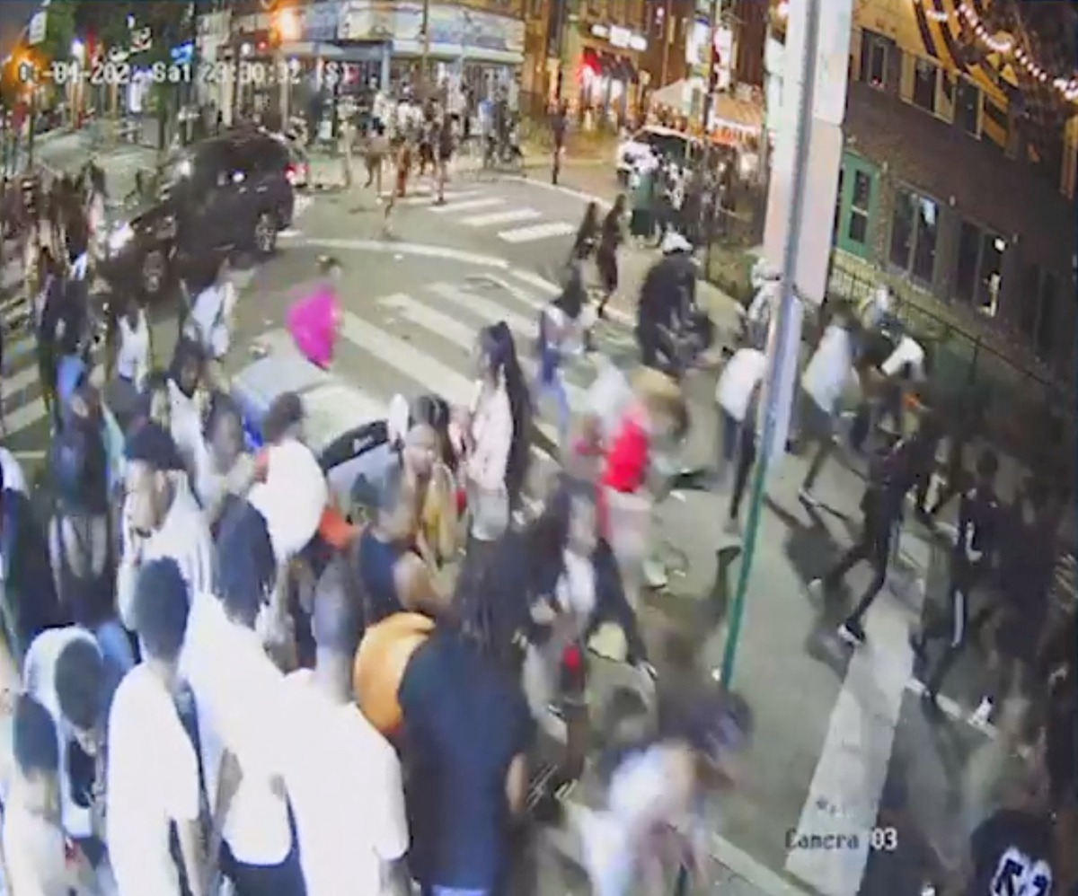 A screen grab from a surveillance video from the shooting shows people on a crowded street running in panic, presumably after gun shots were fired, in Philadelphia, Pennsylvania, U.S., June 4, 2022. South Street CCTV/Handout via REUTERS