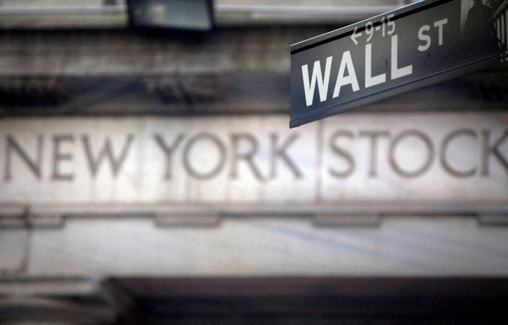 A Wall Street sign is pictured outside the New York Stock Exchange in New York. (REUTERS/Carlo Allegri/File Photo)