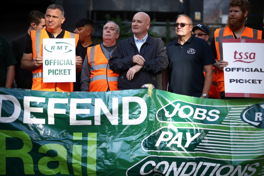 Mick Lynch, General Secretary of the National Union of Rail, Maritime and Transport Workers joins other union members on strike at a picket line outside Euston railway station in London, Britain, August 20, 2022. REUTERS/Henry Nicholls