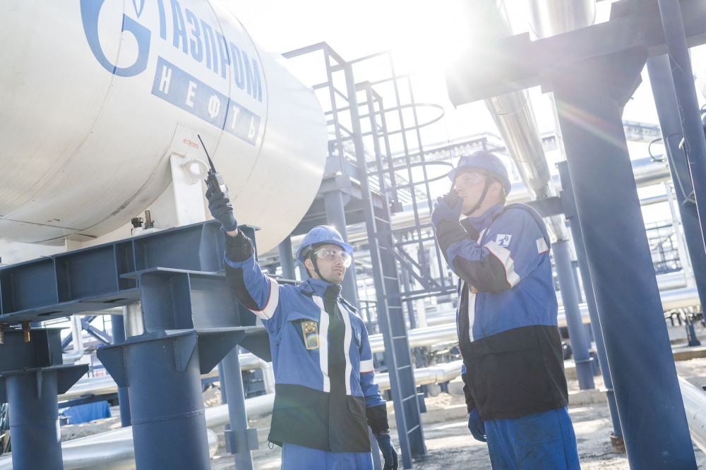 Employees work at the Alexander Zhagrin oilfield operated by Gazprom Neft in Khanty-Mansi Autonomous Area-Yugra, Russia, in this picture released August 30, 2022. (Stoyan Vassev/Press service of Gazprom Neft via Reuters)