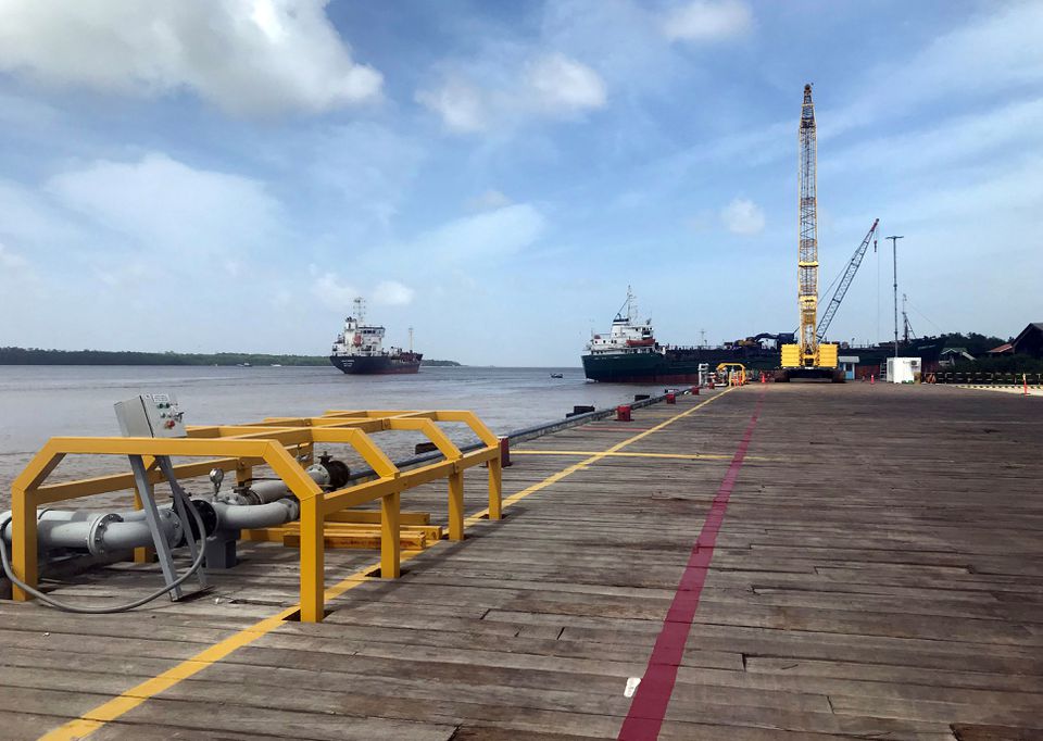 Vessels carrying supplies for an offshore oil platform operated by Exxon Mobil are seen at the Guyana Shore Base Inc wharf on the Demerara River, south of Georgetown, Guyana, January 23, 2020. (REUTERS/Luc Cohen)