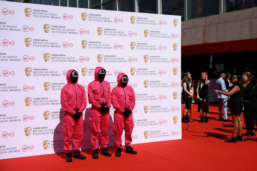  Guests dressed as characters from the series Squid Game arrive at the British Academy Television Awards in London, Britain, May 8, 2022. Reuters/Henry Nicholls/File Photo