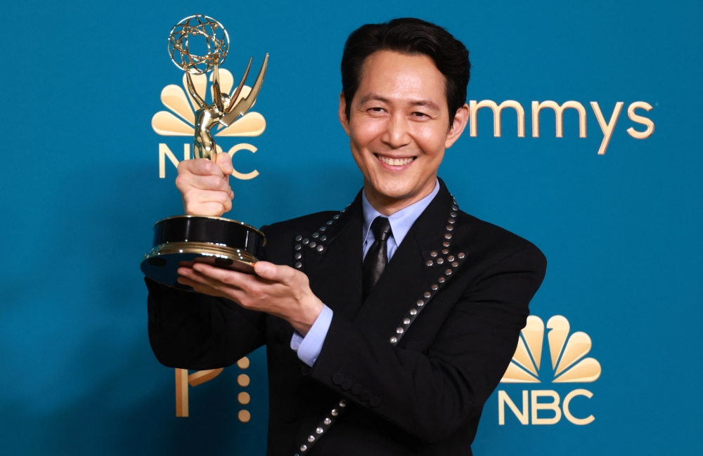 Lee Jung-jae holds his trophy for Outstanding Lead Actor In A Drama Series for 