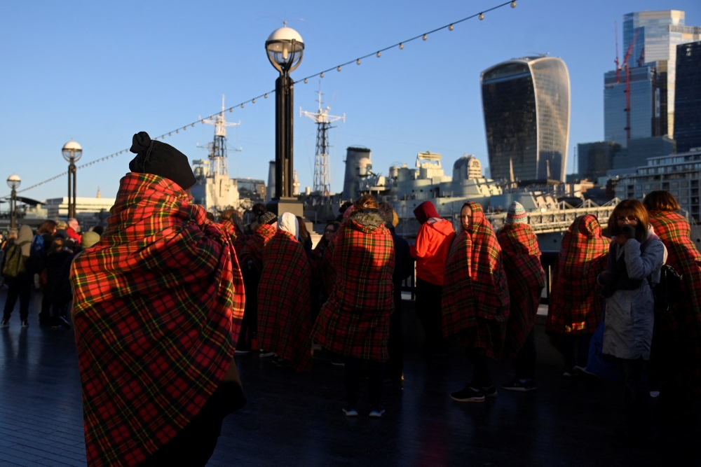 People wear protective blankets as they queue to pay their respects to Britain's Queen Elizabeth following her death, in London, Britain, September 17, 2022. Reuters/Toby Melville