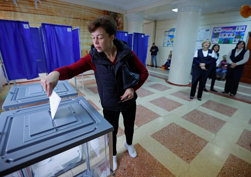 A woman casts her ballot at a polling station during a referendum on the joining of the self-proclaimed Donetsk People's Republic (DPR) to Russia, in Donetsk, Ukraine September 27, 2022. Reuters/Alexander Ermochenko