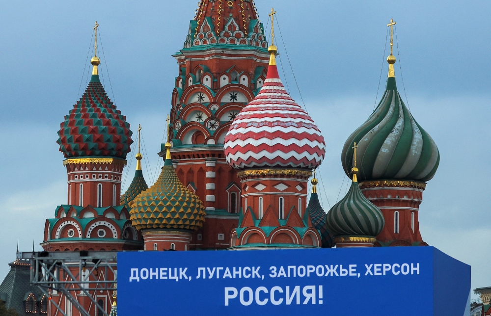 A view shows a banner on a screen, set up ahead of an expected ceremony and concert to declare four Ukraine's self-proclaimed regions part of Russia following recent referendums, near St. Basil's Cathedral in central Moscow, Russia, on September 29, 2022.