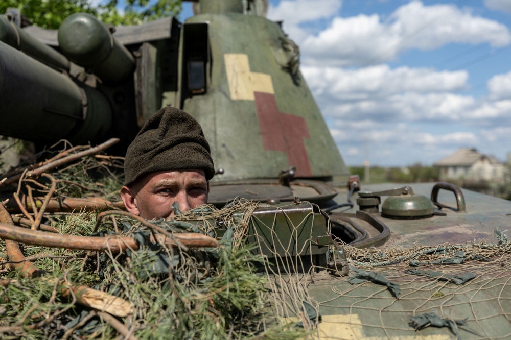 An Ukrainian soldier looks out from a tank, amid Russia's invasion of Ukraine, in the frontline city of Lyman, Donetsk region, Ukraine April 28, 2022. REUTERS/Jorge Silva/File Photo