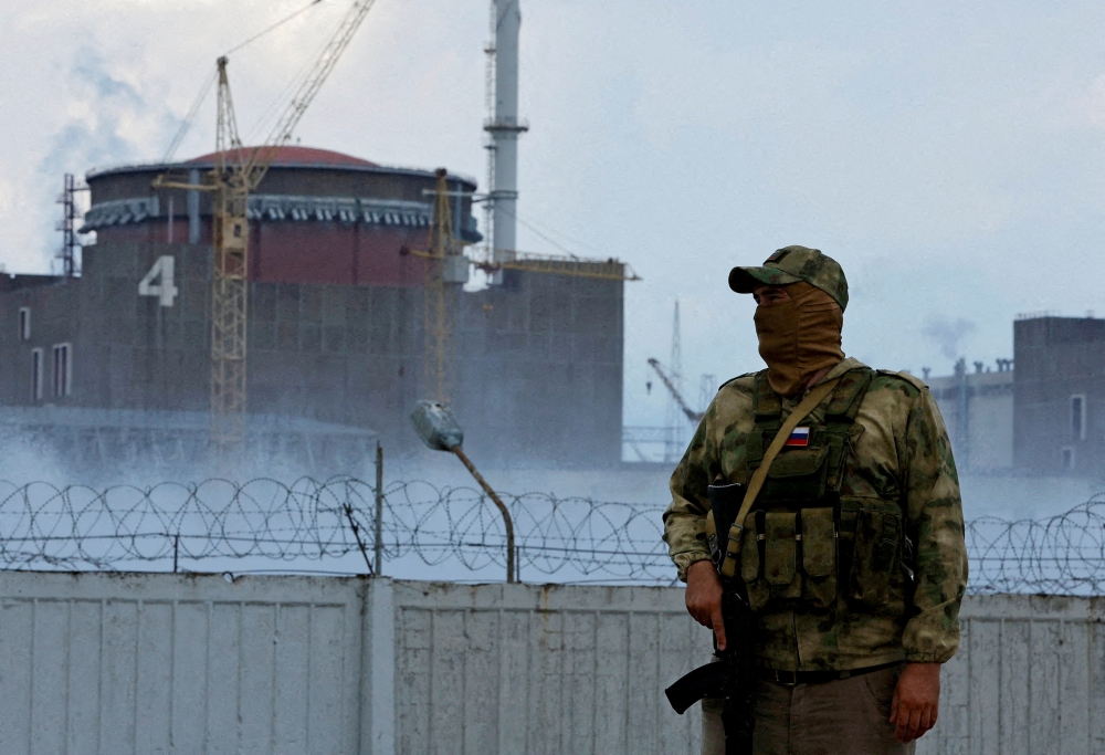 File photo: A serviceman with a Russian flag on his uniform stands guard near the Zaporizhzhia Nuclear Power Plant in the Zaporizhzhia region, Ukraine August 4, 2022. Reuters/Alexander Ermochenko/File Photo