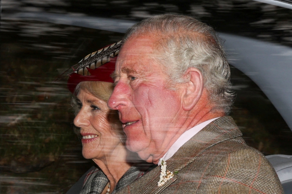 Britain's King Charles and Queen Camilla sit in a car outside Crathie Kirk near Balmoral, Scotland, Britain October 2, 2022. Reuters/Russell Cheyne