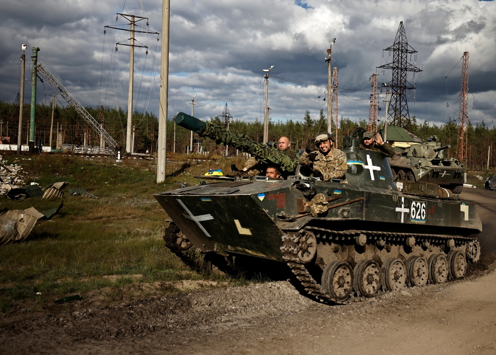 Ukrainians ride an armoured vehicle, amid Russia's attack on Ukraine, in Donesk region, Ukraine, on October 3 2022. REUTERS/Zohra Bensemra