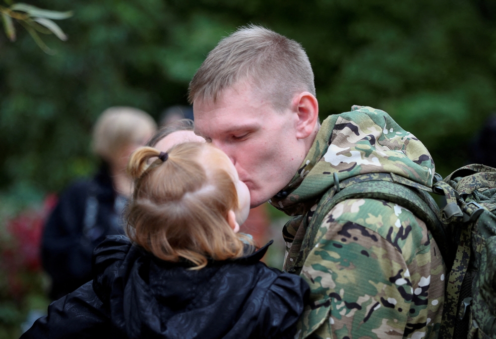 A Russian reservist bids farewell before his departure for a base in the course of partial mobilization of troops in the town of Volzhsky in the Volgograd region, Russia September 28, 2022. Reuters/Stringer/File Photo
 