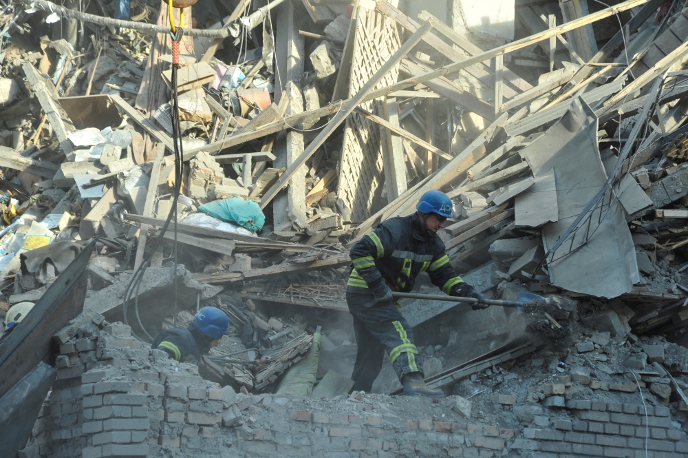 Rescuers work at the site of a residential building heavily damaged by a Russian missile strike, amid their attack on Ukraine, in Zaporizhzhia, Ukraine October 6, 2022. REUTERS/Stringer