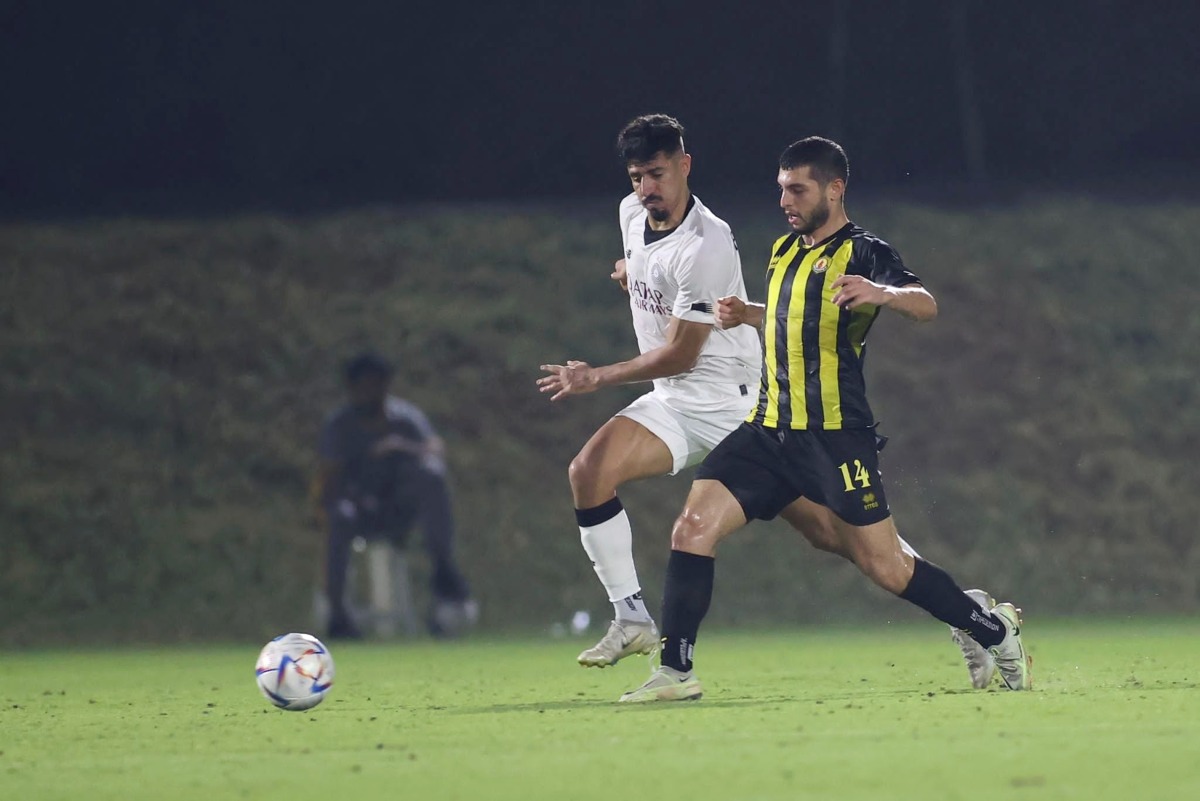 Al Sadd's Baghdad Bounedjah and Qatar SC's Muattaz Majed Bostami in action during yesterday's match.