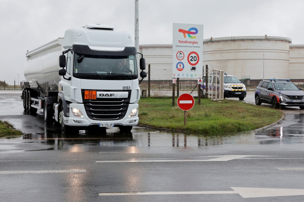 A fuel tanker leaves a TotalEnergies depot and former oil refinery, in Mardyck near Dunkerque, France, on October 13, 2022. REUTERS/Pascal Rossignol/File Photo