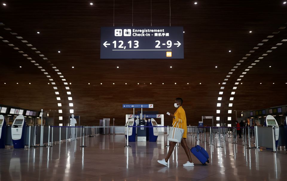 A woman makes her way in the departures area of the Terminal 2E at Charles-de-Gaulle airport in Roissy, near Paris, France, on April 2, 2021.  File Photo / Reuters
