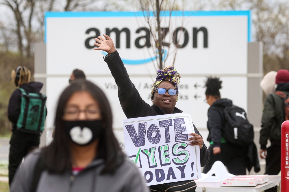 An Amazon Labour Union (ALU) organiser greets workers outside Amazon’s LDJ5 sortation center, as employees begin voting to unionise a second warehouse in the Staten Island borough of New York City on April 25, 2022.  File Photo / Reuters
