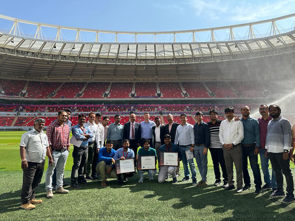 Officials pose for a group photo during a special celebration at Ahmad Bin Ali Stadium.