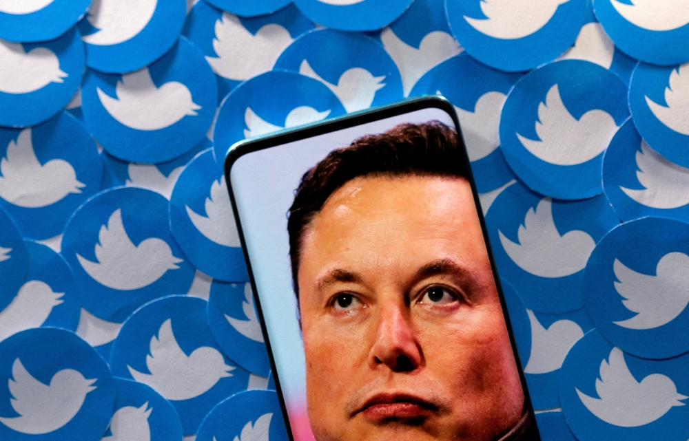 An image of Elon Musk is seen on a smartphone placed on printed Twitter logos in this picture illustration taken April 28, 2022. File Photo / Reuters