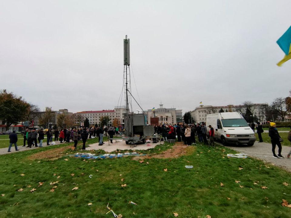 People gather in the central square of Kherson, after Kyivstar engineers installed the first mobile station, in Kherson, Ukraine November 13, 2022. Kyivstar/Handout via REUTERS