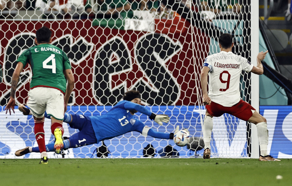 Poland’s Robert Lewandowski has his penalty saved by Mexico’s Guillermo Ochoa during their Group C match at Stadium 974 yesterday. REUTERS