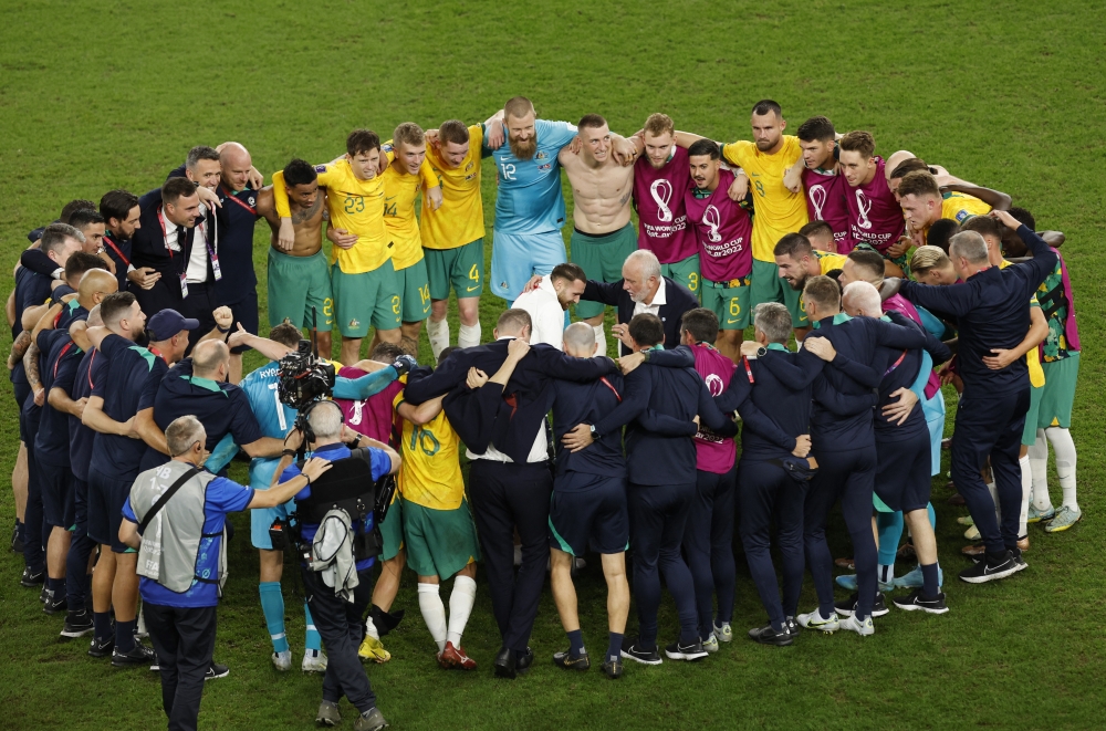 Australia coach Graham Arnold celebrates with his players and staff after qualifying for the knockout stages at Qatar World Cup 2022 Group D match against Denmark at the Al Janoub Stadium on November 30, 2022. (REUTERS/Albert Gea)