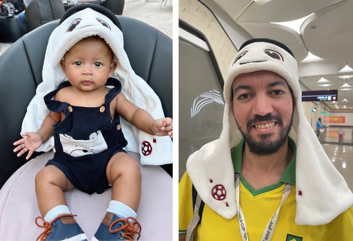 From left: Four month old T’kare Prince wearing a La’eeb plush hat and Abdulkaram from Algeria proudly wearing a La’eeb plush hat.