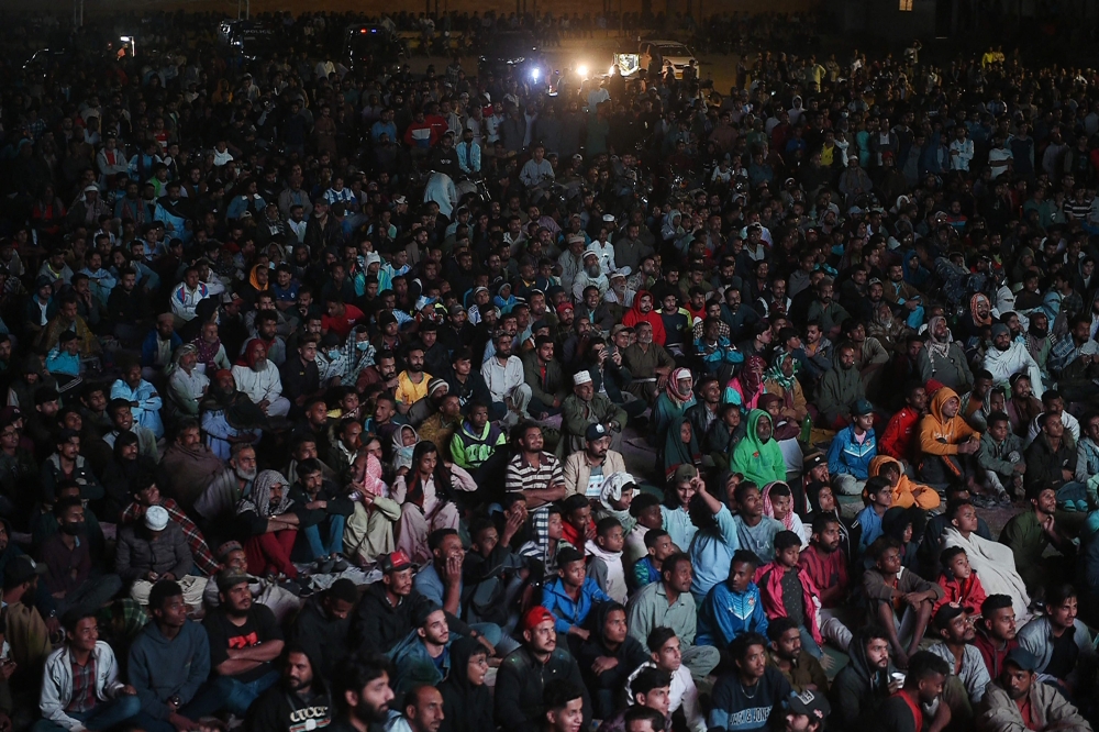 Pakistani football fans watch the live broadcast of the Qatar 2022 World Cup football semi-final match between Argentina and Croatia in the Lyari neighbourhood of Karachi on December 14, 2022. (Photo by Rizwan Tabassum / AFP)