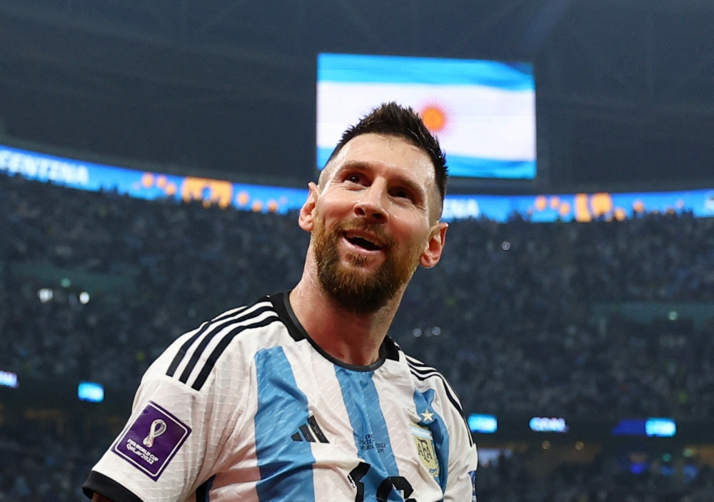 December 13, 2022 Argentina's Lionel Messi celebrates their third goal scored by Julian Alvarez REUTERS/Molly Darlington