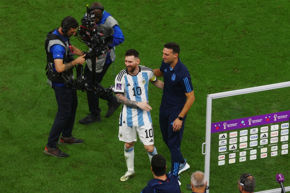 Argentina's Lionel Messi and coach Lionel Scaloni celebrate after the match as Argentina progress to the final Reuters/Paul Childs