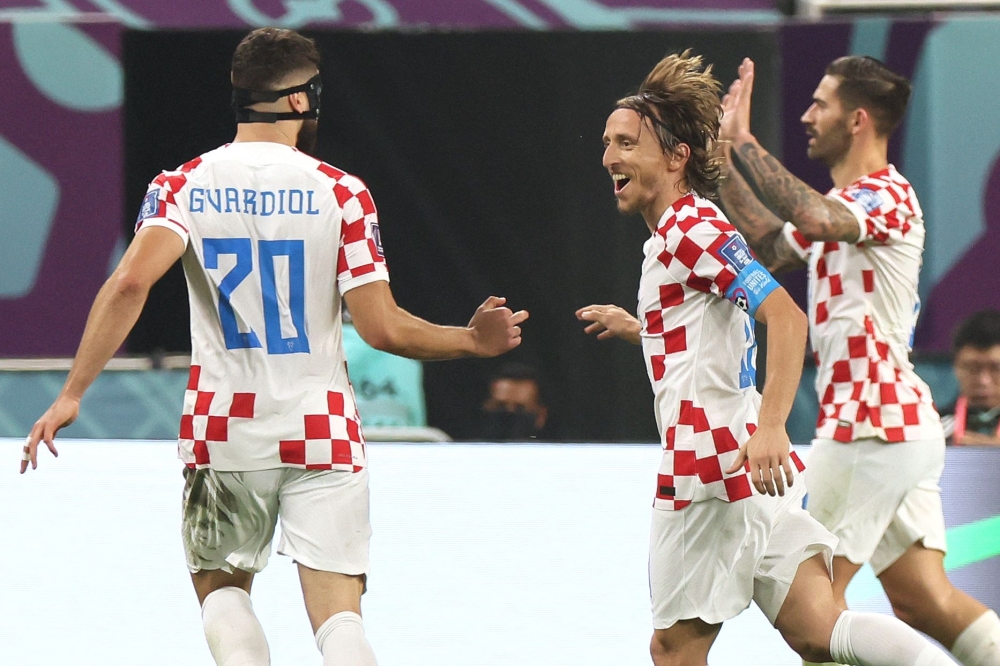 Croatia's midfielder #10 Luka Modric (second left) and his teammates celebrate scoring their team's second goal during the Qatar 2022 World Cup third place play-off football match between Croatia and Morocco at Khalifa International Stadium in Doha on December 17, 2022. (Photo by JACK GUEZ / AFP)