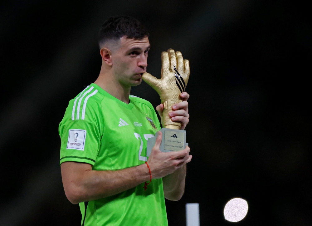 Argentina's Emiliano Martinez after he is awarded the golden glove award during the trophy ceremony of the FIFA World Cup Qatar 2022 at the Lusail Stadium, Lusail, Qatar, on December 18, 2022. REUTERS/Hannah Mckay