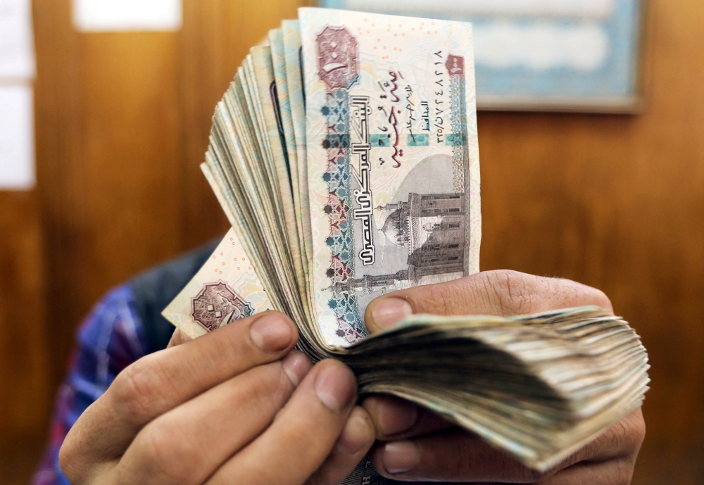 File Photo: An employee counts Egyptian pounds at a foreign exchange office in central Cairo, Egypt, March 20, 2019. (REUTERS/Mohamed Abd El Ghany)