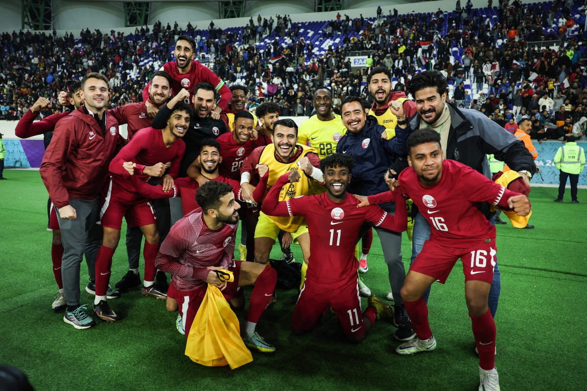 Qatar players and officials celebrate after qualifying for the Arabian Gulf Cup semi-finals, yesterday. 